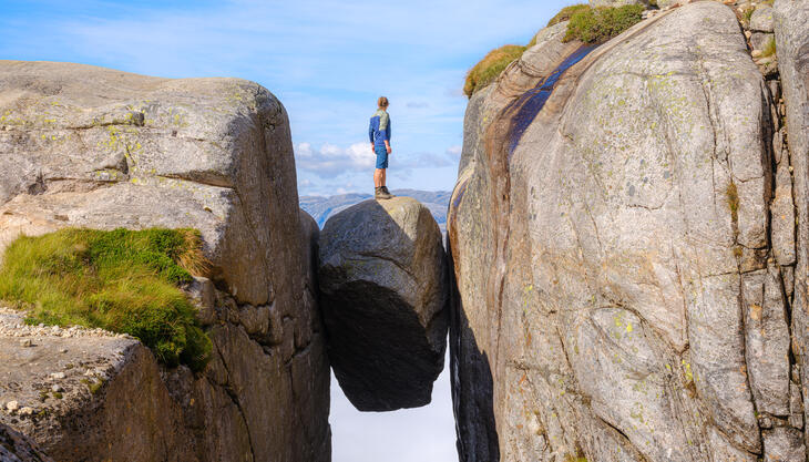 Person standing on top of the Kjerag boulder