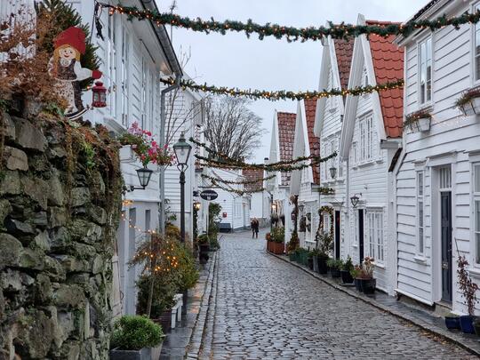 Julepyntede gater i Gamle Stavanger. Brosteinsgater og hvite trehus.