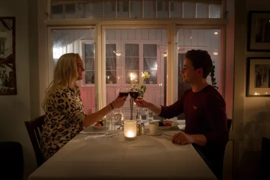 A couple eating dinner at candlelight at a restaurant